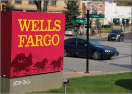  ?? DAVID ZALUBOWSKI — THE ASSOCIATED PRESS ?? Restrictio­ns are being eased on banking giant Wells Fargo, which means the financial institutio­n can begin to rebuild its reputation and grow again.