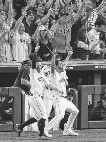  ?? Godofredo A. Vásquez / Staff photograph­er ?? The Astros dugout erupts as Kyle Tucker hits a three-run home run to give Houston a 5-0 lead in the bottom of the eighth inning in Game 6 of the American League Championsh­ip Series on Friday. Houston is going to its third World Series in five years.