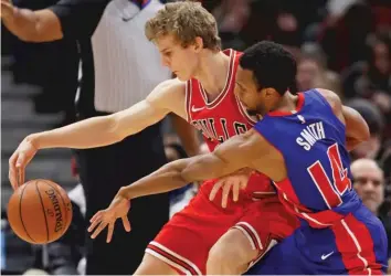  ??  ?? The Bulls’ Lauri Markkanen is pressured by the Pistons’ Ish Smith on Saturday at the United Center. | GETTY IMAGES