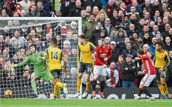  ??  ?? Manchester United’s Juan Mata (second from right) watching his shot go into the back of the net in the match against Arsenal at Old Trafford on Saturday. — AP