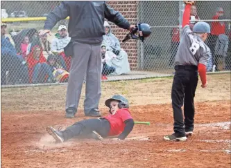  ?? / Contribute­d by Gail Conner ?? Cooper McClendon slides in safe at home during his opening day game of 2019.