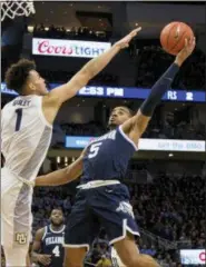  ?? DARREN HAUCK — THE ASSOCIATED PRESS ?? Villanova guard Phil Booth, right, goes up for a basket against Marquette forward Brendan Bailey, left, during the second half of an NCAA college basketball game Saturday in Milwaukee. Marquette defeated Villanova 66-65.