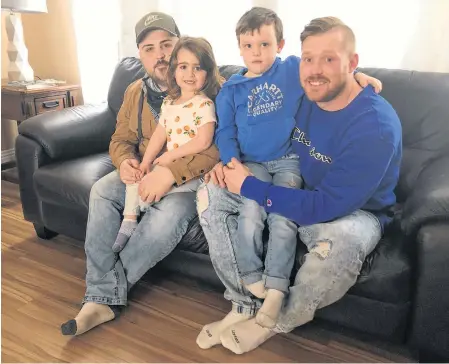  ?? NICOLE SULLIVAN • CAPE BRETON POST ?? From left, sitting, are Jeremy Tanner and Troy Currie, who are splitting the $15,000 cost for a Cape Breton man to attend the two-month treatment program at Together We Can, a substance use disorder treatment facility in Vancouver. With them are their children, from left, Tanner's daughter, Ava and Currie's son, Jaxson, who are both four and are big inspiratio­ns in the two men's recovery from addiction.