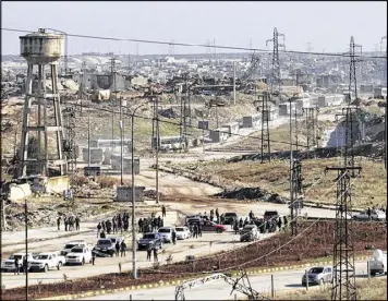  ?? SANA VIA ASSOCIATED PRESS ?? Green government buses carry residents evacuating from eastern Aleppo, Syria, on Thursday. The Russian military said over 1,000 people have been evacuated from Aleppo under a cease-fire deal reached with Syrian rebels.