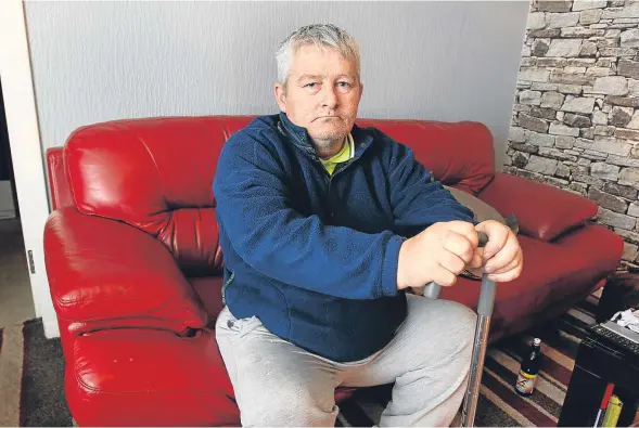  ??  ?? Garry Millar, pictured at his home in Fintry, who now has only his stick to help him get about after his mobility scooter was stolen.