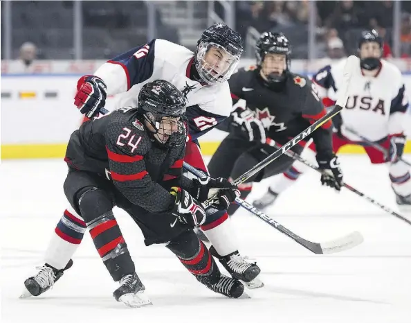  ?? CODIE MCLACHLAN/THE CANADIAN PRESS ?? Team Canada’s Xavier Parent collides with Team USA’s Luke Toporowski during semifinal action Friday night at the Hlinka Gretzky Cup. Justice was not served, writes Terry Jones, as Team Canada eked out a 6-5 overtime victory.