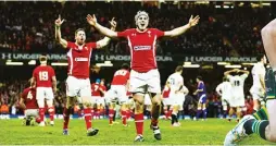  ??  ?? Tough times: Wales celebrate in 2013 while, right, Tom Wood trucks it up for Saints