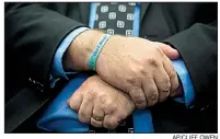  ?? AP/CLIFF OWEN ?? Tony Montalto, whose daughter Gina Rose Montalto was killed in the 2018 shooting at Marjory Stoneman Douglas High School in Parkland, Fla., wears a bracelet with his daughter’s name on it. “Please, learn from our experience,” he said. “It happened to us, and it could happen to your community, too.”