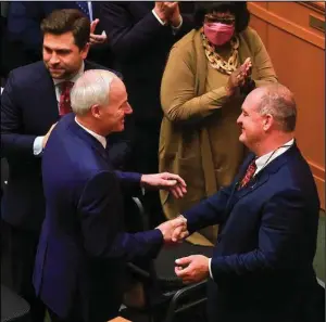  ?? (Arkansas Democrat-Gazette/Staton Breidentha­l) ?? Gov. Asa Hutchinson (left) greets Senate President Pro Tempore Jimmy Hickey on Monday in the House chamber of the state Capitol before the governor’s final State of the State speech. More photos at arkansason­line.com/215session/.