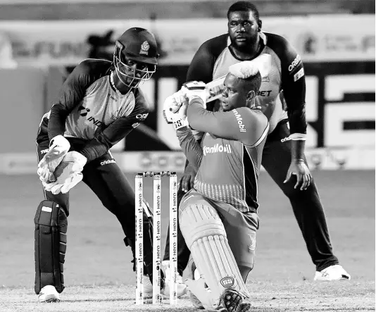  ?? RANDY BROOKS - CPL T20 ?? Shimron Hetmyer of Guyana Amazon Warriors hits a six as Andre Fletcher (left) and Rahkeem Cornwall (right) of St Lucia Zouks look on during the Hero Caribbean Premier League match 24 at the Brian Lara Cricket Academy on September 2 in Tarouba, Trinidad and Tobago.