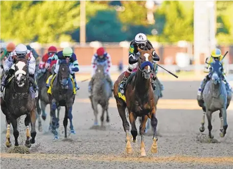  ?? MARK HUMPHREY/AP ?? Jockey John Velazquez rides Authentic, second from right, as they cross the finish line to win the 146th running of the Kentucky Derby.