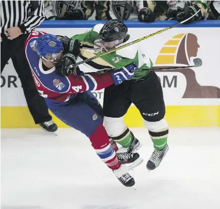  ?? GREG SOUTHAM ?? The Edmonton Oil Kings’ Aaron Irving is hit by the Prince Albert Raiders’ Dalton Yorke Friday during WHL action in Edmonton. The Oil Kings won 3-1 on Trey Fix-Wolansky’s game winner.