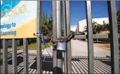  ?? Mel Melcon Los Angeles Times ?? LAUSD CAMPUSES will be closed indefinite­ly. Above, a locked gate at Los Angeles High School.