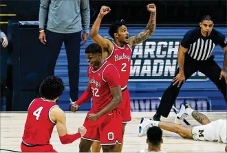  ?? PHOTOS BY MICHAEL CONROY / AP ?? Ohio State’s Duane Washington Jr. (from left), E.J. Liddell and Musa Jallow celebrate after Michigan’s final shot bounced off the bracket in a Big Ten semifinal Saturday in Indianapol­is.