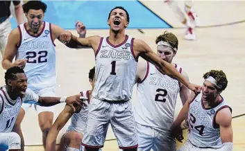  ?? MICHAEL CONROY/ASSOCIATED PRESS ?? Gonzaga guard Jalen Suggs (1) celebrates after making the game-winning basket at the overtime buzzer against UCLA on Saturday to help send the Zags to the national title game Monday.