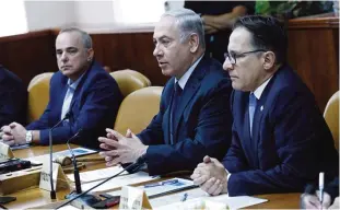  ??  ?? JERUSALEM: Israeli Prime Minister Benjamin Netanyahu, center, chairs the weekly cabinet meeting at his office in Jerusalem. —AFP