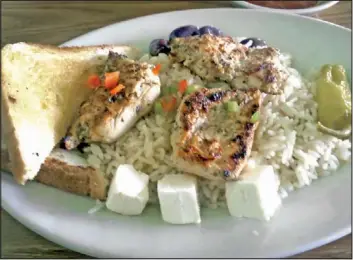  ??  ?? The Grecian Chicken at Grapevine Cafe came with white rice, chunks of feta, Kalamata olives and Texas toast.