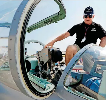  ?? [PHOTO BY STEVE SISNEY, THE OKLAHOMAN] ?? Jay Duechting gets into the cockpit of his Aero L-39 Albatros recently in Norman.