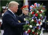  ?? Associated Press ?? ■ President Donald Trump participat­es in a wreath laying ceremony Monday at the Tomb of the Unknown Soldier in Arlington National Cemetery.