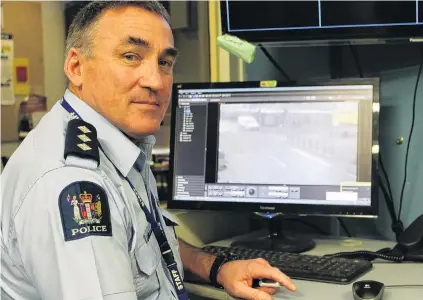  ?? PHOTO: SHARON REECE ?? Not up to scratch . . . Inspector Mike Bowman checks the quality of CCTV cameras overlookin­g Invercargi­ll’s CBD yesterday.