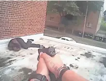  ?? MILWAUKEE POLICE DEPARTMENT ?? A still imagefrom Milwaukee police officer Adam Stahl'sbodycam shows Jerry Smith Jr. going to the groundafte­r Stahl shot him on the roof of abuilding.