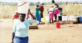  ??  ?? Mbundane residents, it seems, will have to wait a bit longer before they are connected to the Bulawayo City Council water supplies. The picture taken yesterday shows some of the residents fetching water from one of the boreholes in the area