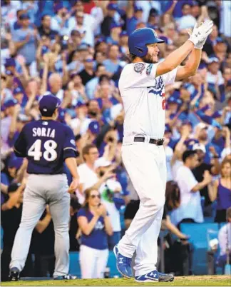  ?? Wally Skalij Los Angeles Times ?? CLAYTON KERSHAW celebrates scoring a run against the Brewers in Game 5. Kershaw was masterful on the mound and helped his cause by drawing a walk that led to him scoring.