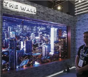  ?? — AP ?? Samsung’s ‘The Wall’ modular television on display at the Samsung booth during CES is a whopping 146in.