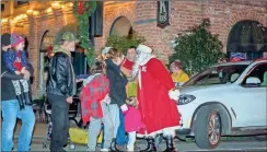  ?? R. Steven Eckhoff, File ?? Santa greets parade attendees, both young and old, at the 2019 parade in Cave Spring.