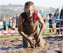  ??  ?? Emily Westhorp finsihed caked with mud after making her way through the mud pit.