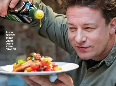  ??  ?? Just a drizzle: Jamie Oliver pours some olive oil