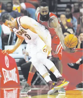  ?? Brett Coomer / Houston Chronicle ?? Houston’s James Harden picks the pocket of Cleveland’s Kevin Love. Harden recorded five steals as the Rockets extended their win streak to four games.