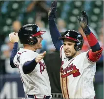  ?? ERIC GAY — THE ASSOCIATED PRESS ?? Atlanta Braves’ Travis d’arnaud, right, celebrates with teammate Freddie Freeman after hitting a three-run home run during the seventh inning in Game 1of the National League Division Series against the Miami Marlins on Tuesday in Houston.