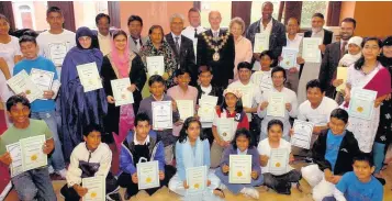  ??  ?? The mayor with successful members of the after school language club held at Castlemere Community Centre