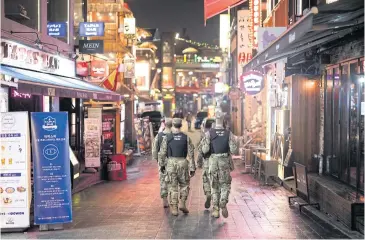  ?? BLOOMBERG ?? US military police patrol a street at night in the Itaewon area of Seoul, South Korea on Saturday.