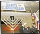  ??  ?? Honor guard at menorah-lighting ceremony at FDNY’s Brooklyn headquarte­rs Wednesday.
