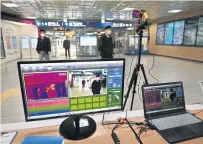  ??  ?? A thermal camera system monitors the body heat of passengers at a railway station in the South Korean city of Daegu, where dozens of Covid-19 infections have been reported.