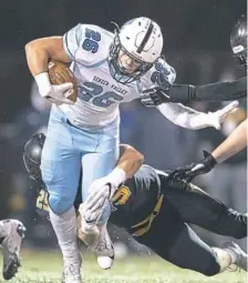  ??  ?? Seneca Valley’s Jake Mineweaser, front, breaks a tackle by North Allegheny’s Cade Hoke.