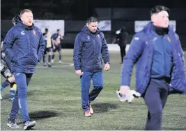  ??  ?? Down and out East Kilbride caretaker boss Jim Paterson (centre), players and staff trudge off after their Scottish Cup exit to BSC Glasgow