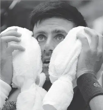  ?? FRANK FRANKLIN II/THE ASSOCIATED PRESS ?? Serbia’s Novak Djokovic takes a breather and cools down during his 6-3, 3-6, 6-4, 6-0 win over Marton Fucsovics of Hungary on a blistering Tuesday at the U.S. Open in New York.