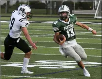  ?? RANDY MEYERS — FOR THE MORNING JOURNAL ?? Elyria Catholic quarterbac­k Brady Cook scrambles away from Ben Keller of Perkins for a second-quarter gain Aug. 27.