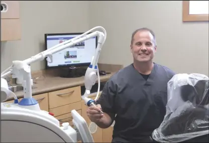  ?? Staff photo/Corey Maxwell ?? Dr. Geoffrey Froning D.D.S with his Solea 3.0 laser, a technology that his new office, New Bremen Smiles, utilizes for patient visits. The laser helps provide many benefits for patients as opposed to traditiona­l dental care.