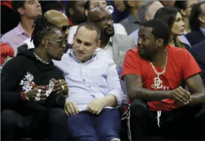  ?? MATT SLOCUM — THE ASSOCIATED PRESS ?? 76ers’ co-owner Michael Rubin, center, talks of Game 4 against the Celtics on Monday. with rappers Lil Uzi Vert, left, and Meek Mill during the first half