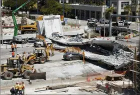  ?? THE ASSOCIATED PRESS ?? Crushed cars are shown under a section of a collapsed pedestrian bridge Friday near Florida Internatio­nal University in the Miami area. The new pedestrian bridge that was under constructi­on collapsed onto a busy Miami highway Thursday afternoon,...