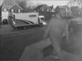  ?? SUBMITTED PHOTO ?? Surveillan­ce image captures suspect stealing a package from a home on Terwood Road in Drexel Hill Tuesday night. Police are looking for the Enterprise box truck located in the background that the suspect fled in with the stolen items.