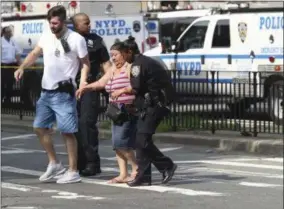  ?? THE ASSOCIATED PRESS ?? Police help people cross the street outside the Bronx Lebanon Hospital in New York after a gunman opened fire there on Friday, June 30, 2017.