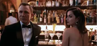  ?? ?? LAST LOOK: James Bond (Daniel Craig) and Paloma (Ana de Armas) in ‘No Time to Die,’ which opened this weekend.