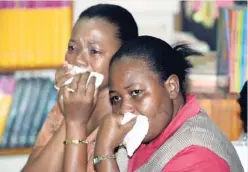  ??  ?? Bridget Brooks-White (foreground) and Cheryl Taylor-Turgott, teachers at the Dunrobin Primary School, are in tears during a counsellin­g session yesterday, as the school family mourns the death of Janice Atkinson-Reid, who was a teacher at the school.