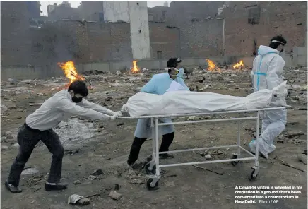  ?? Photo / AP ?? A Covid-19 victim is wheeled in for cremation in a ground that’s been converted into a crematoriu­m in New Delhi.