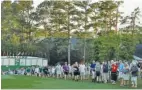  ?? AP PHOTO/CHARLIE RIEDEL ?? Fans walk along the first hole’s fairway at Augusta National Golf Club on April 11, 2019, during the opening round of the Masters.